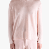 Light pink sweater,worn by a person, showing the sweater fit