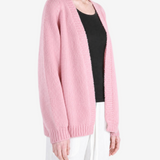 Pink knitwear worn by a person, showing the knitwear fit