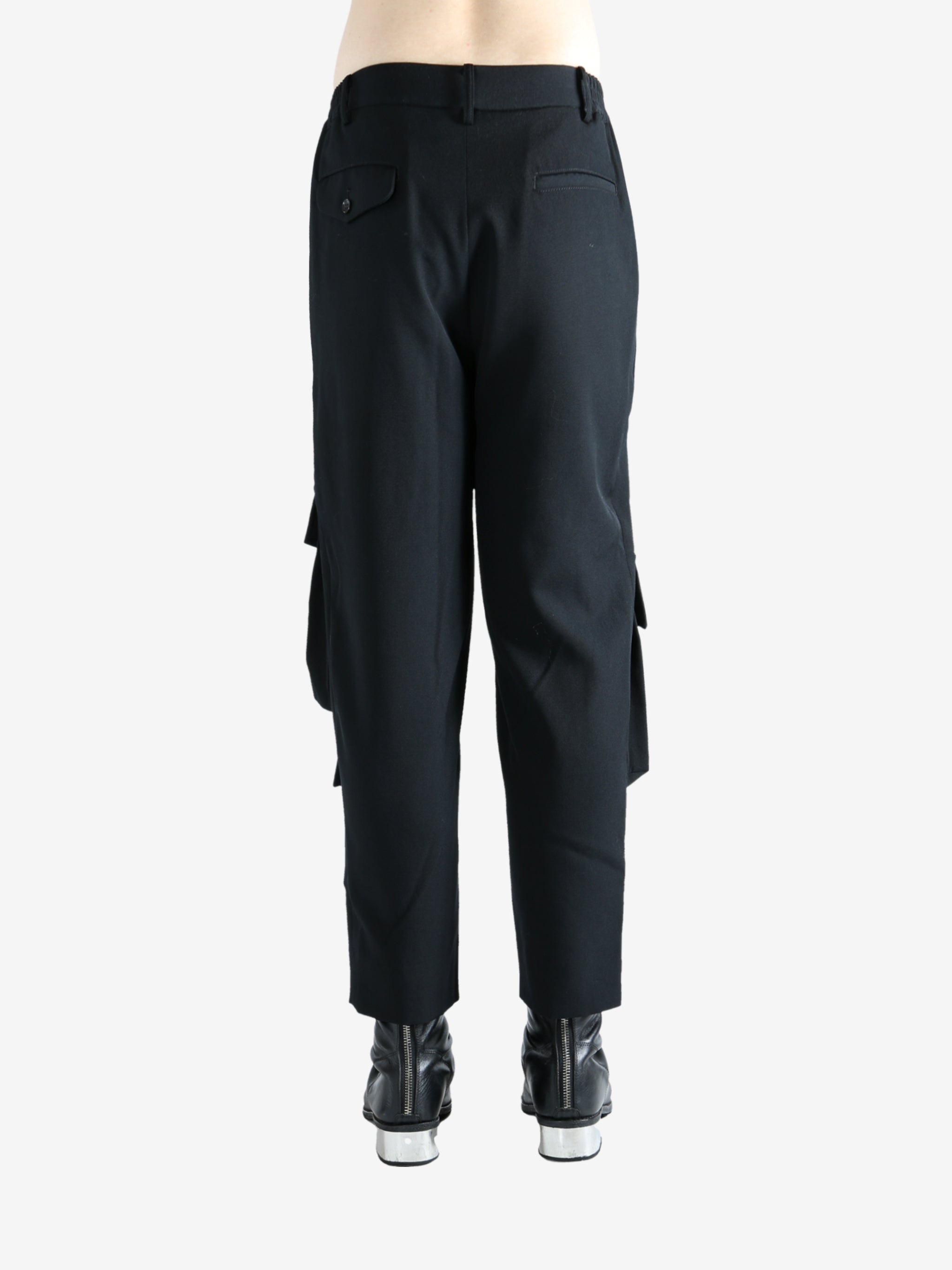 Black pants worn by a person, showing the pants fit