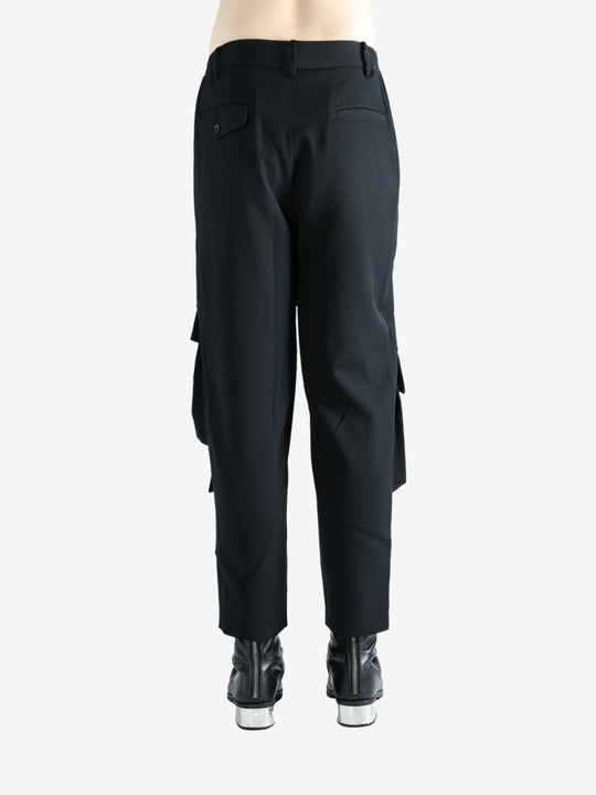 Black pants worn by a person, showing the pants fit