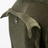 Close up of green knitwear, showing texture of the cotton fabric