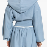 Blue hoodie worn by a person, showing the hoodie fit