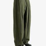 Green pants worn by a person, showing the pants' fit