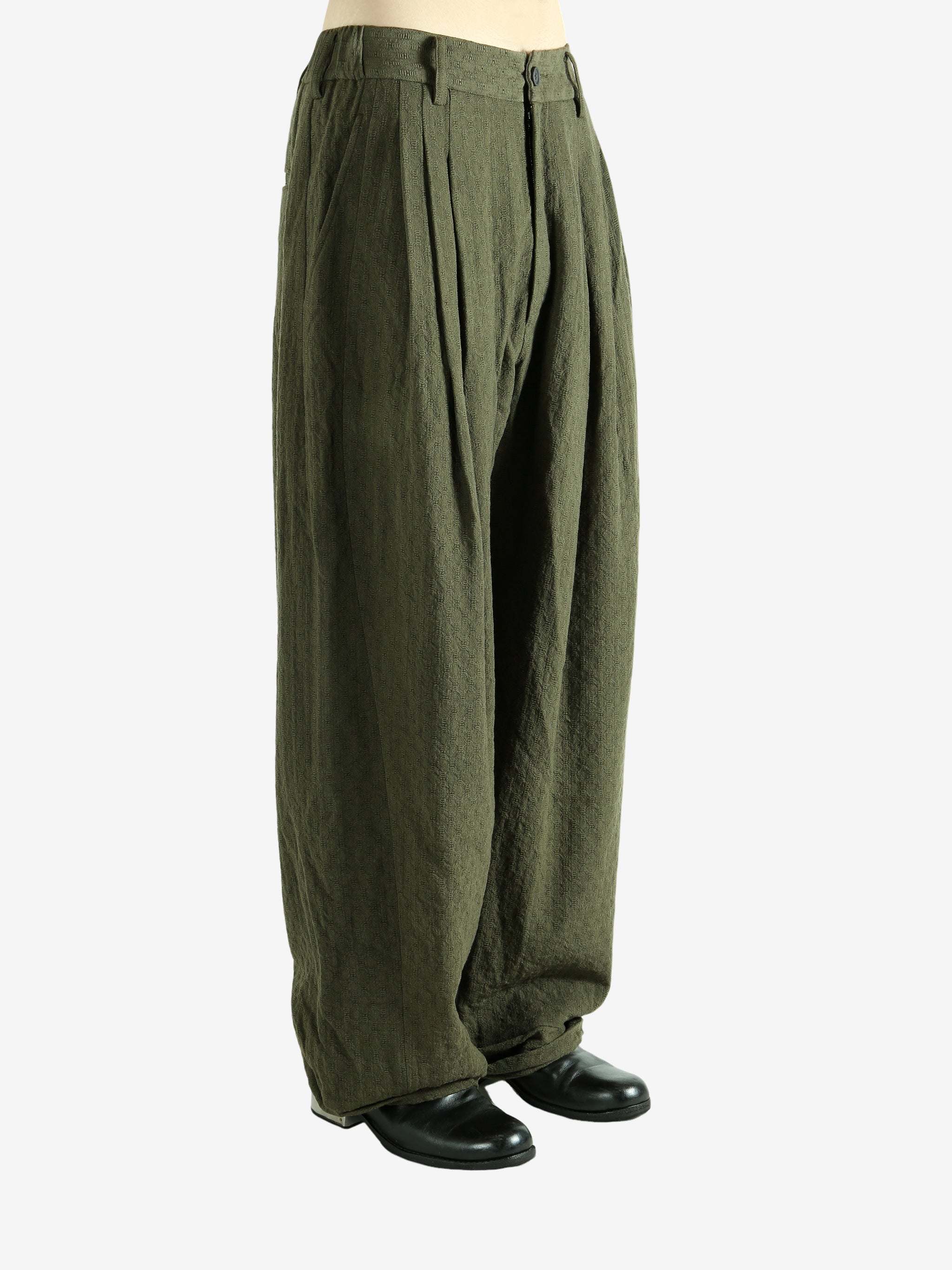 Green pants worn by a person, showing the pants' fit