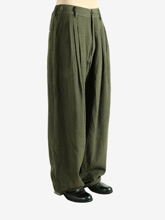 Green pants worn by a person, showing the pants' fit