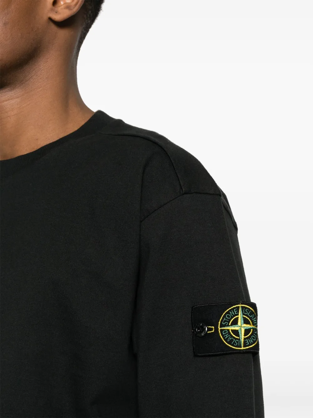 Black hoodie worn by a person, showing the hoodie fit