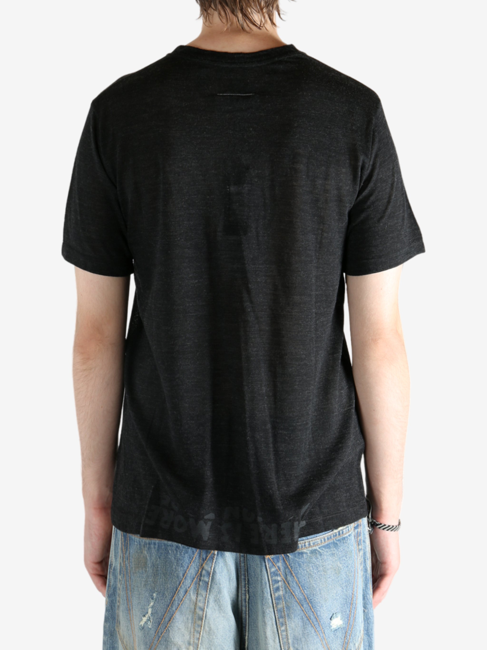 Black shirt worn by a person, showing the shirt fit