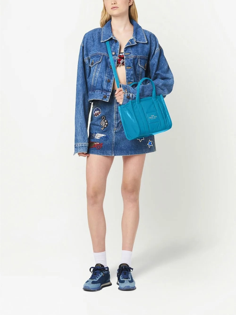 Blue bag carried by a person, showing the bag's fit