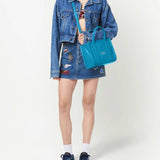 Blue bag carried by a person, showing the bag's fit