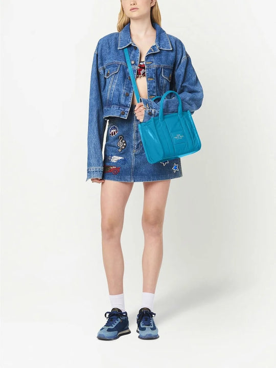 Blue bag carried by a person, showing the bag's fit