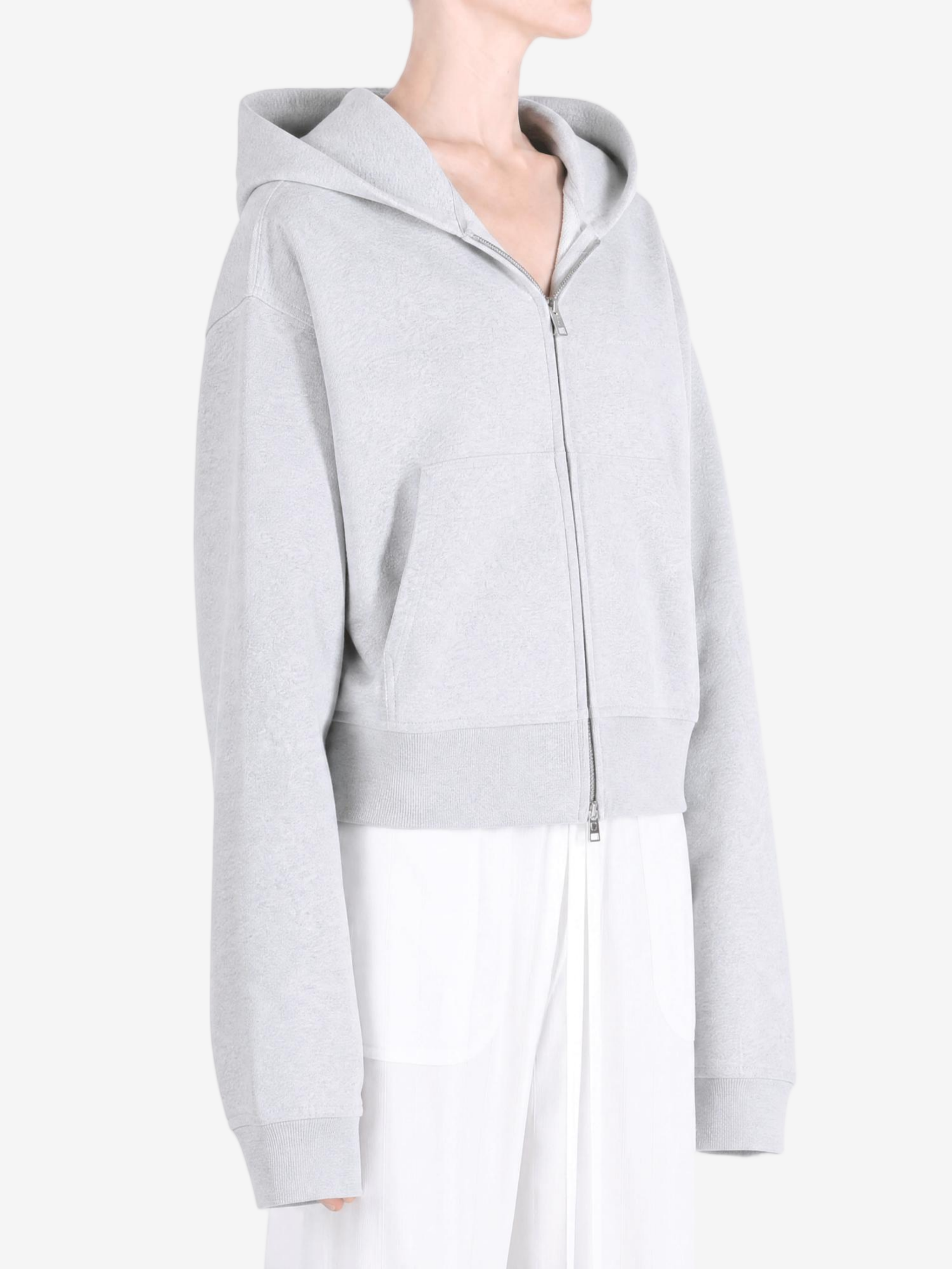 Grey hoodie worn by a person, showing the hoodie fit