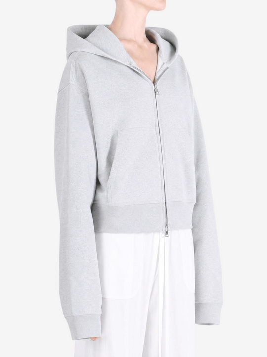 Grey hoodie worn by a person, showing the hoodie fit