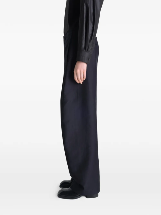 Black pant worn by a person, showing the pant's fit