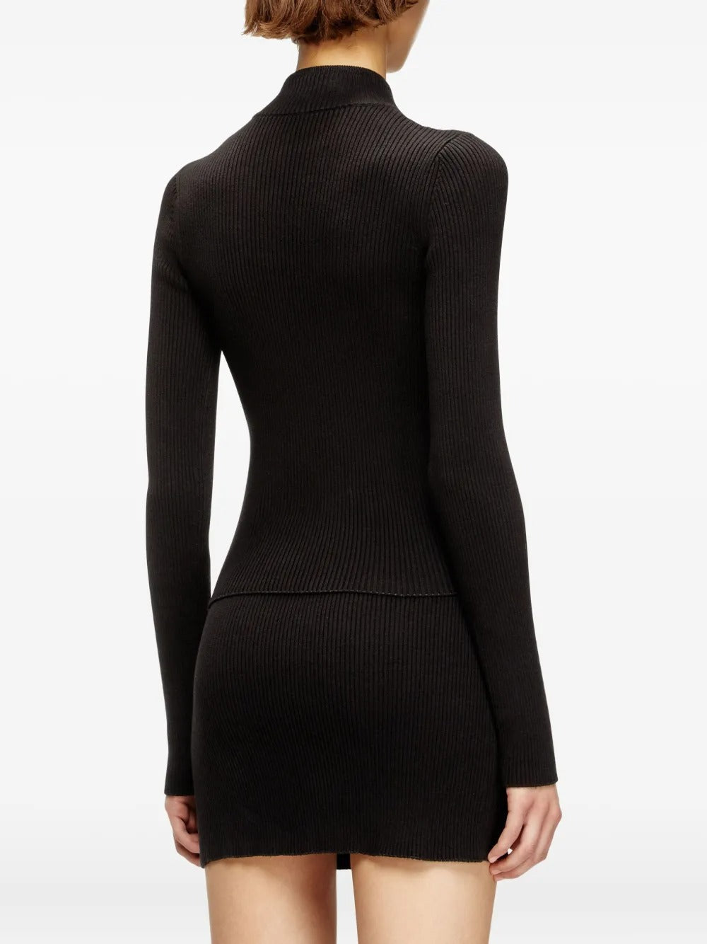 Black knitwear worn by a person, showing the knitwear's fit