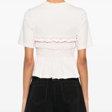 pink t-shirt worn by a person, showing the  t-shirt fit