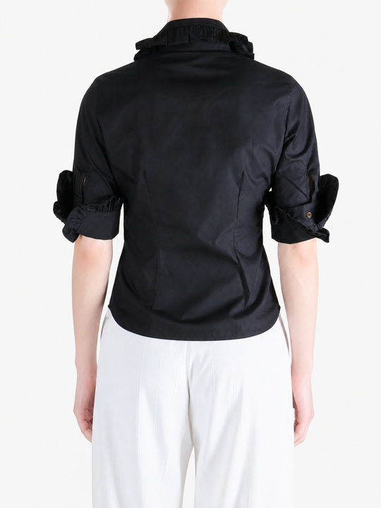 Black shirt worn by a person, showing the shirt fit