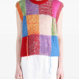 Red knitwear worn by a person, showing the knitwear fit