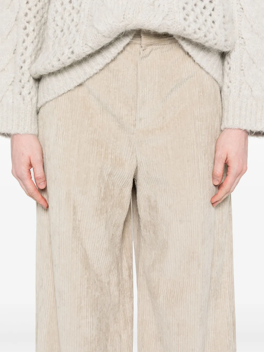 Tan pants worn by a person, showing the pants fit