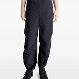 Black pants worn by a person, showing the pants' fit