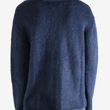 blue sweater worn by a person, showing the sweater fit