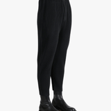 Black pant worn by a person, showing the pants fit