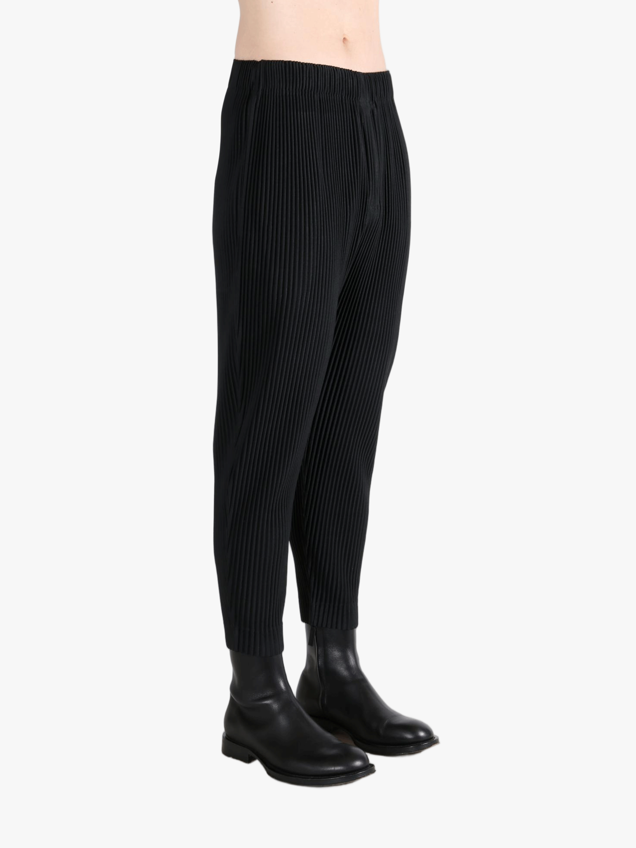 Black pant worn by a person, showing the pants fit
