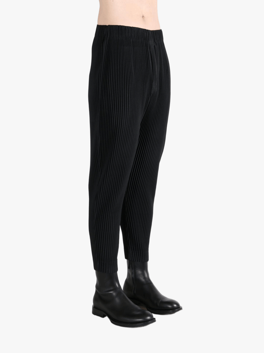 Black pant worn by a person, showing the pants fit