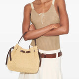Tan bags worn by a person, showing the bags' fit 