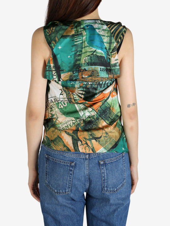 Green top worn by a person, showing the top’s fit