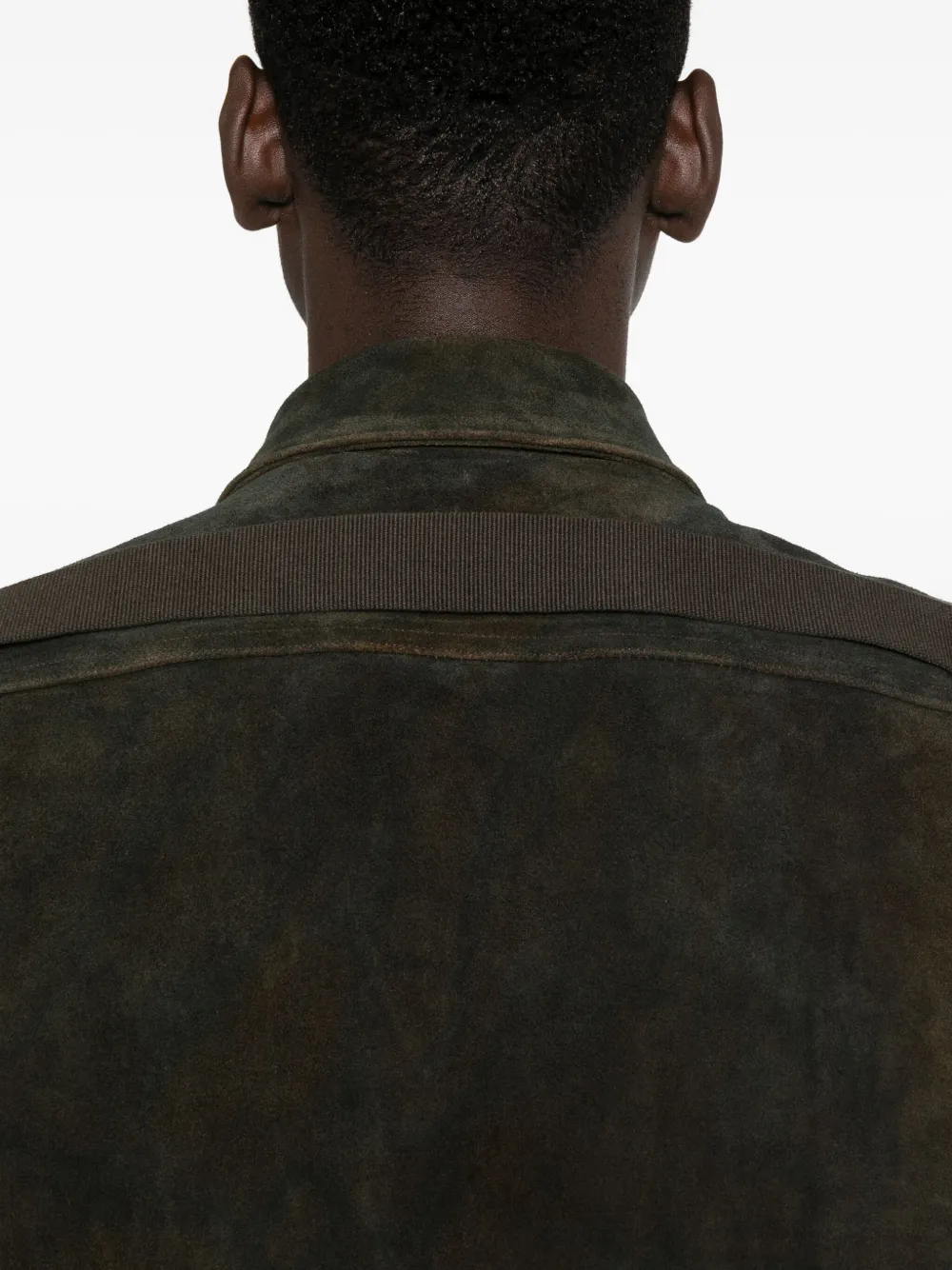 Close up of the green jacket, showing texture of the leather fabric