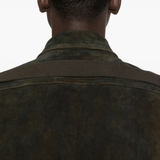 Close up of the green jacket, showing texture of the leather fabric