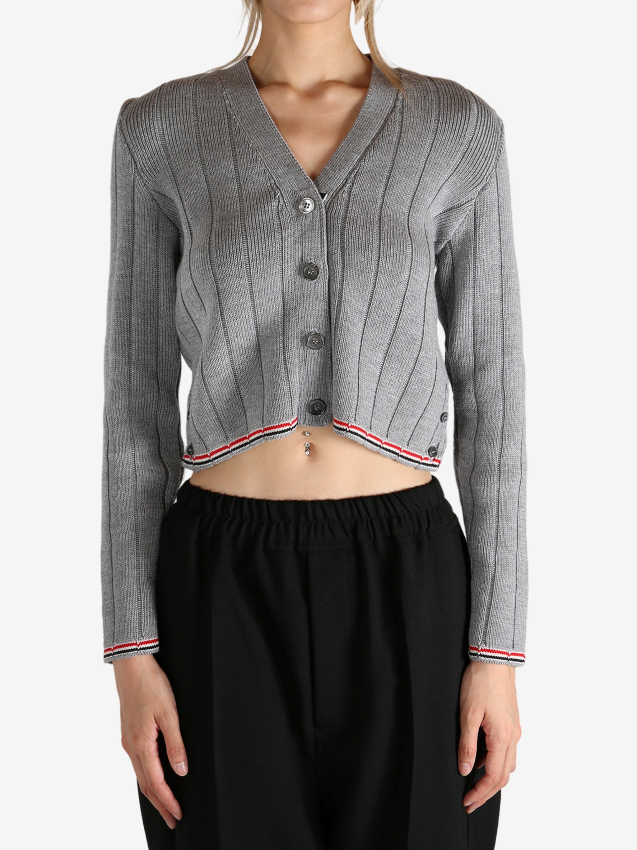 Grey knitwear worn by a person, showing the knitwear's fit