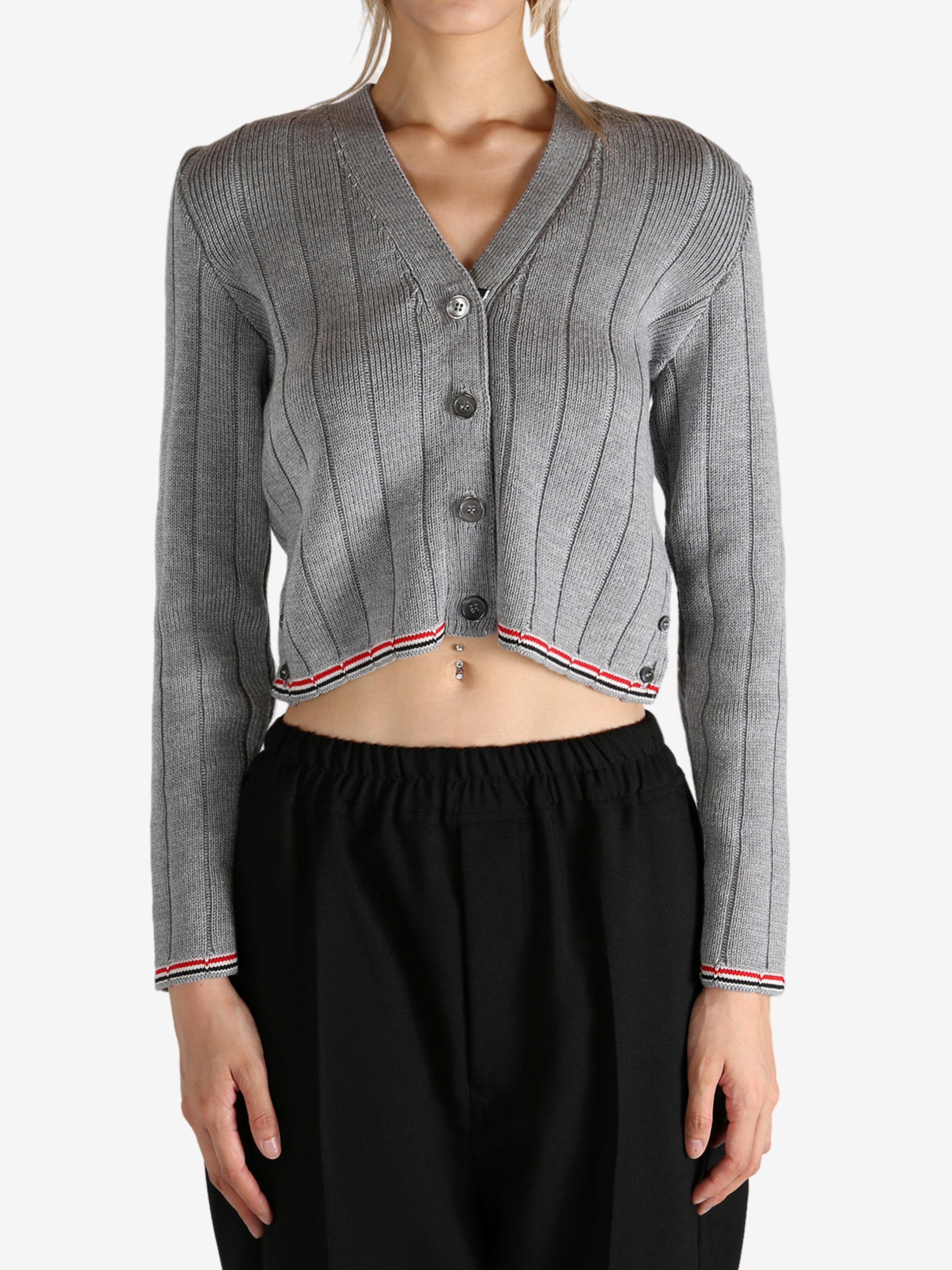 Grey knitwear worn by a person, showing the knitwear's fit