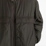 Close up of the brown coat, showing texture of the polyamide fabric
