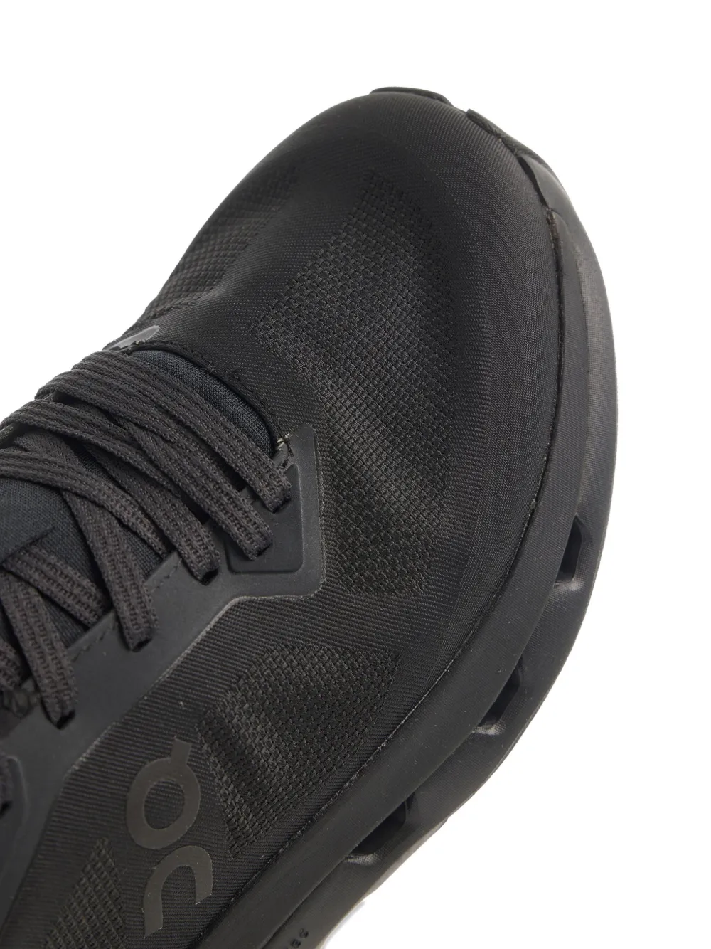 close up of black sneakers, showing texture of the Polyester fabric