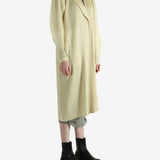 Yellow coat worn by a person, showing the coat's fit