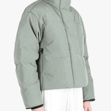 Green jacket worn by a person, showing the jacket fit