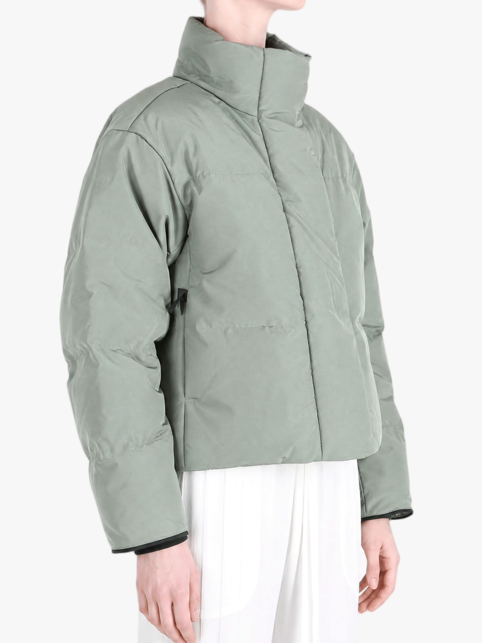 Green jacket worn by a person, showing the jacket fit