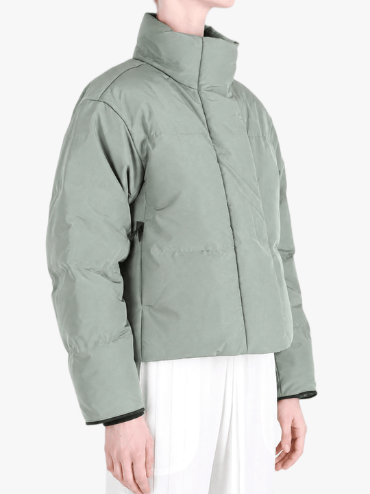 Green jacket worn by a person, showing the jacket fit