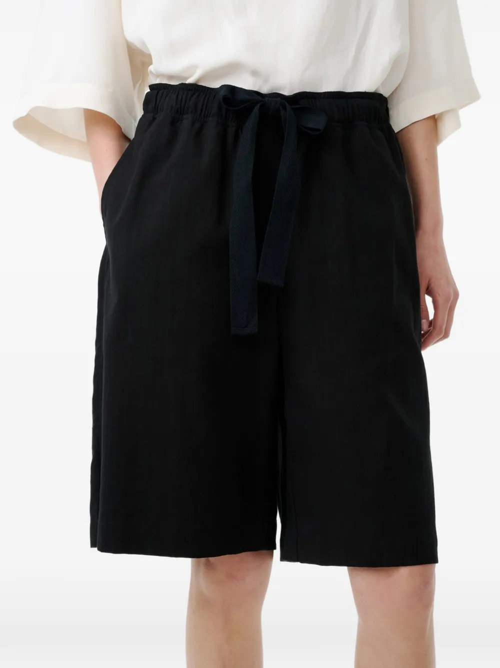Black shorts worn by a person, showing the shorts's fit