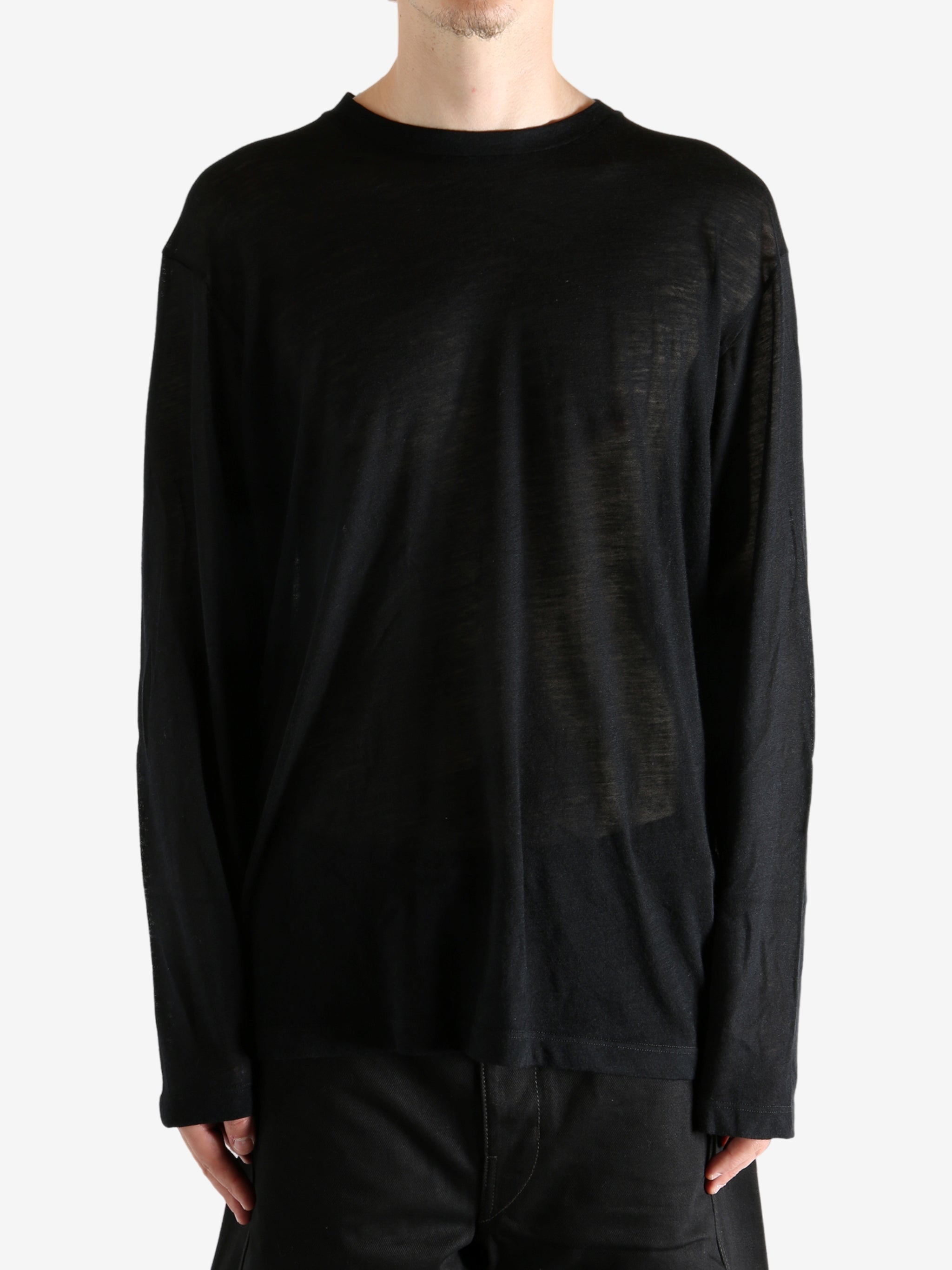 Black top worn by person, showing the top's fit