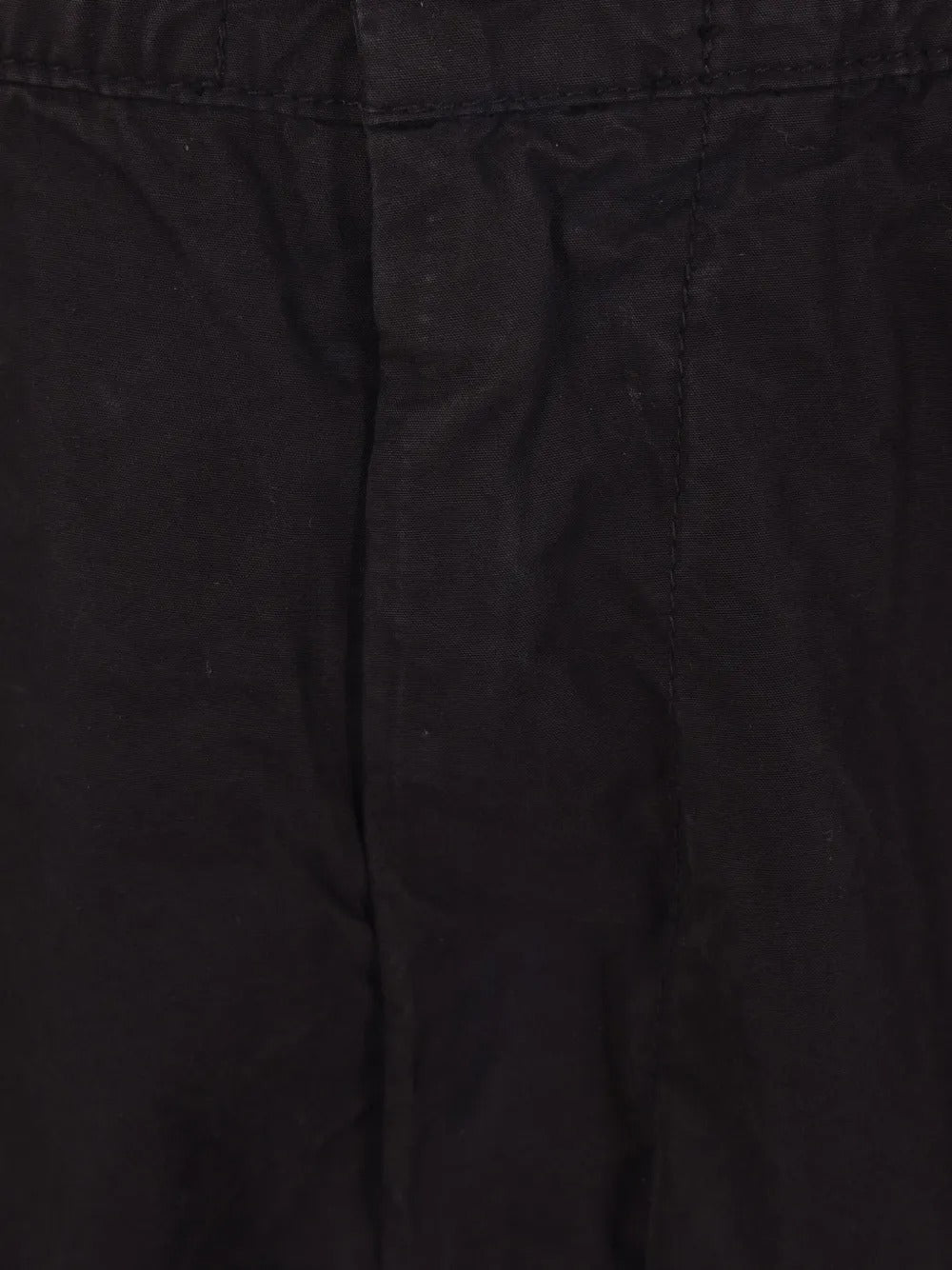 Close up of black pants, showing texture of the cotton fabric