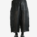 Black pants worn by a person, showing the pants' fit