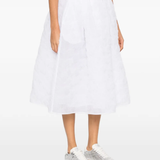 white skirt worn by a person, showing the skirt  fit