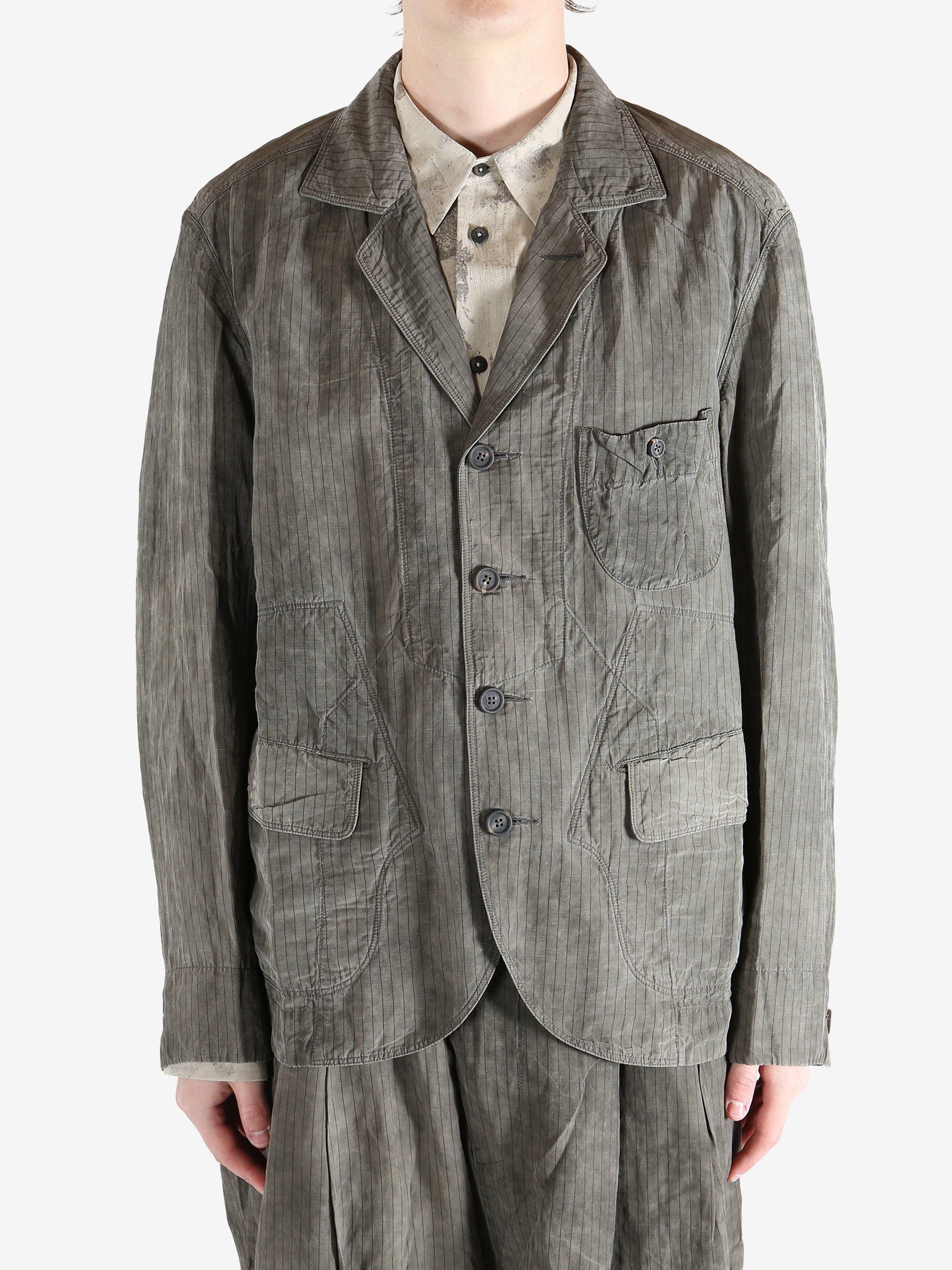 Grey jacket worn by a person, showing the jacket fit