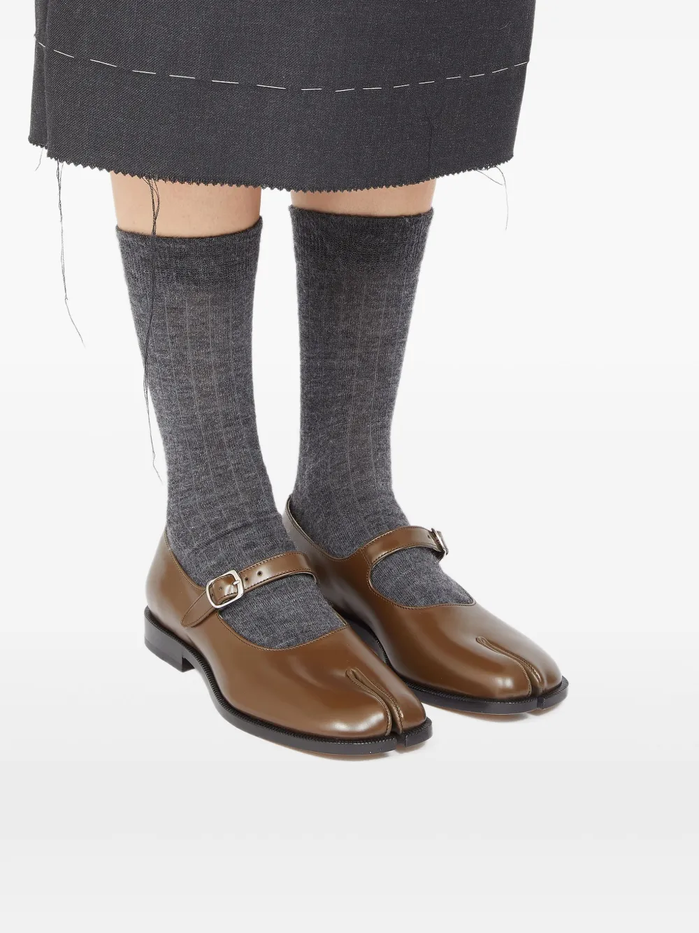 Brown shoes worn by a person, showing the shoes's fit