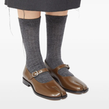 Brown shoes worn by a person, showing the shoes's fit