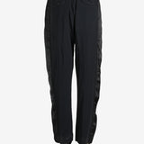 Black pants worn by a person, showing the pants fit