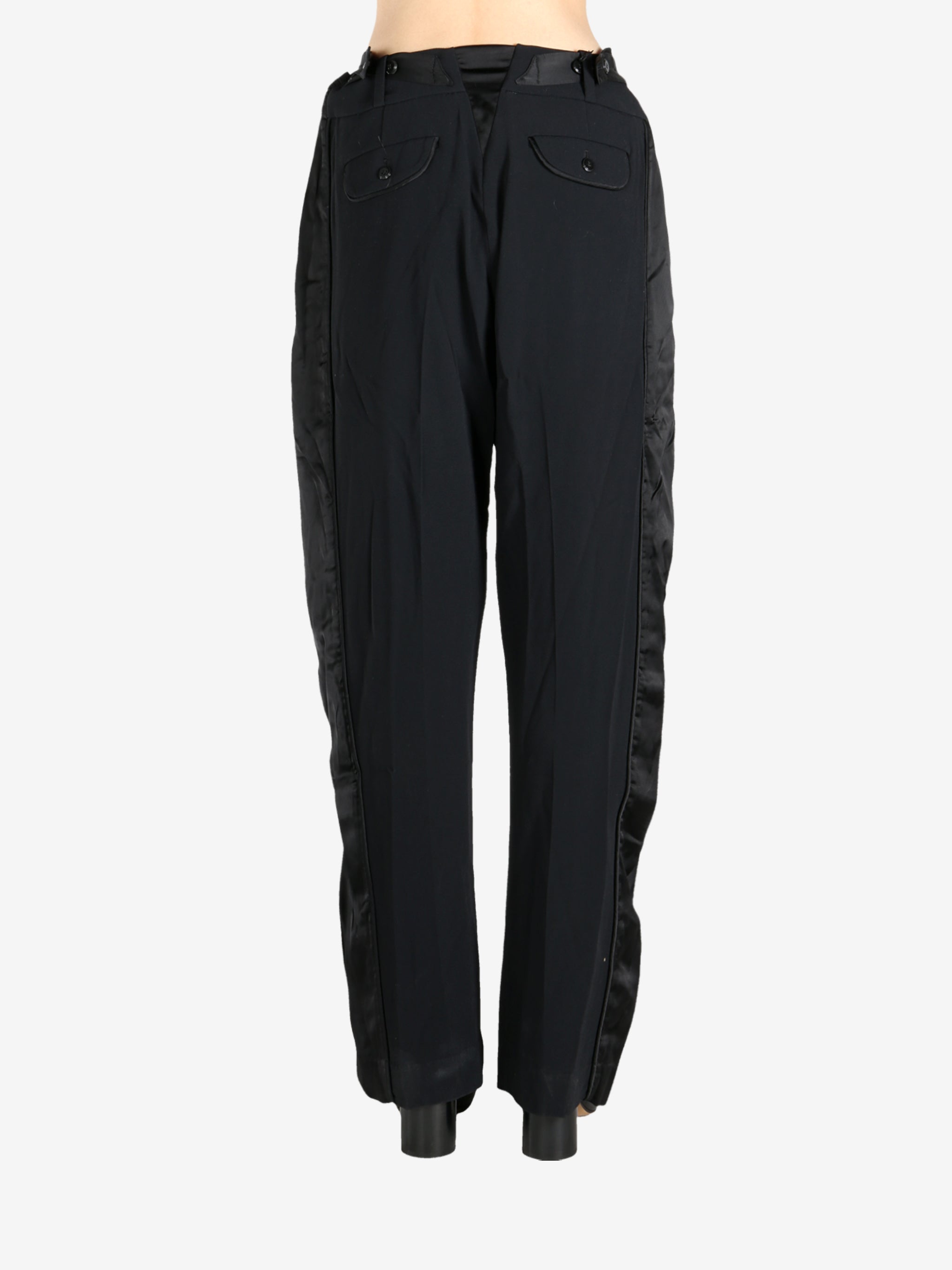 Black pants worn by a person, showing the pants fit