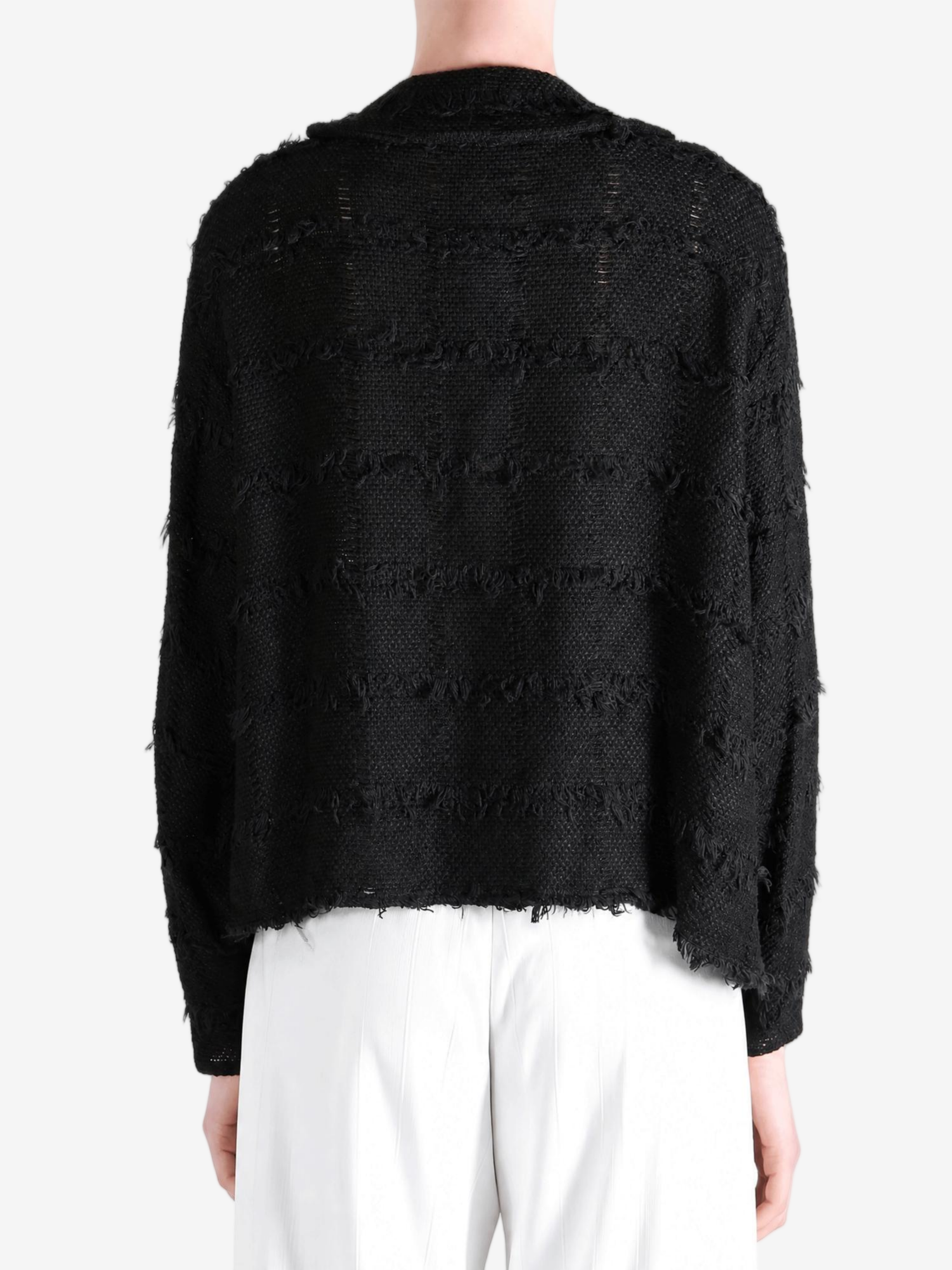 Black shirt worn by a person, showing the shirt fit